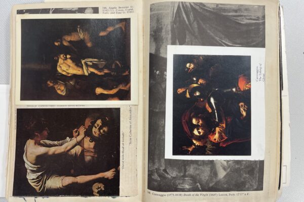 open book with polaroid photos of caravaggio's paintings spread over it_victor pasmore