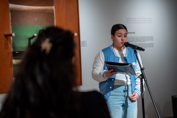 Person reading poem at an open mic event