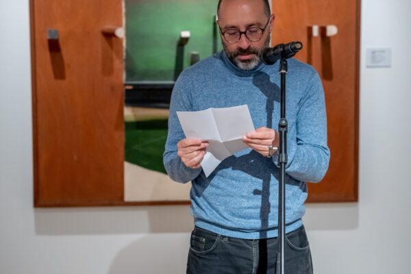 Person reading poem at an open mic event