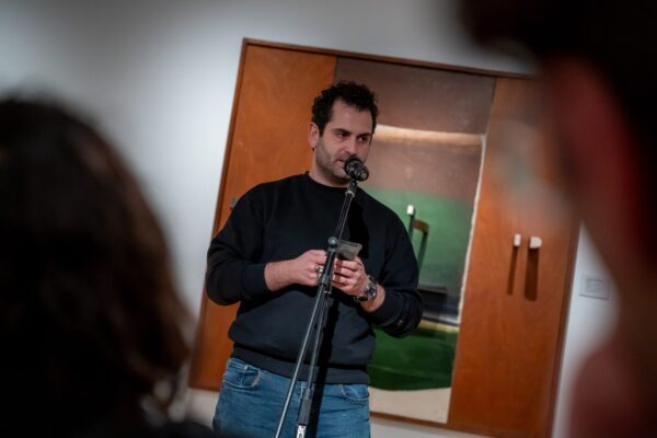 Person reading poem at an open mic event