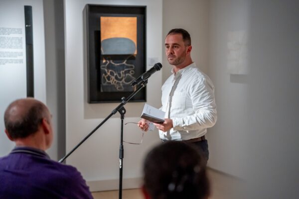 Person reading poem at an open mic event