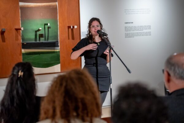 Person reading poem at an open mic event