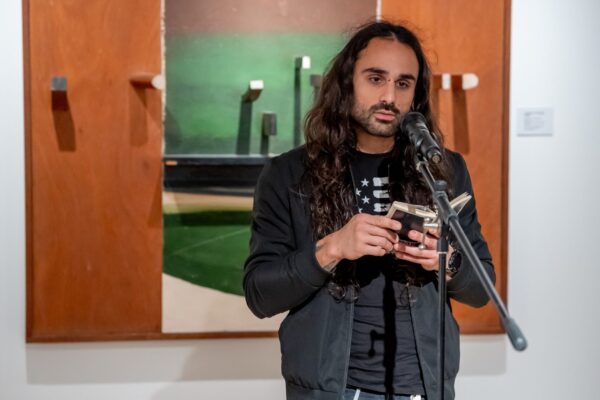 Person reading poem at an open mic event