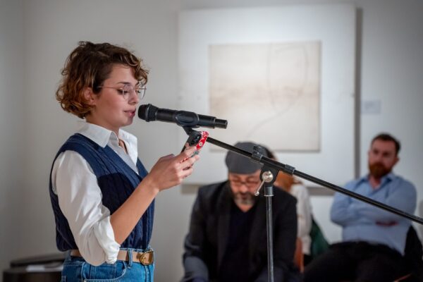 Person reading poem at an open mic event