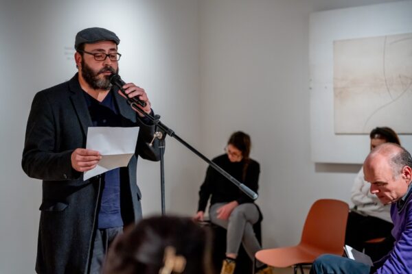 Person reading poem at an open mic event